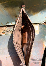 Image on the interior of the yipee kiyay clutch wallet. Brown cloth interior with 1 bill pocket, 6 card slots, 1 zipper pocket, inspirational quote "All You Need Is Love", and Leather STS ranchwear patch. Zipper closure.
